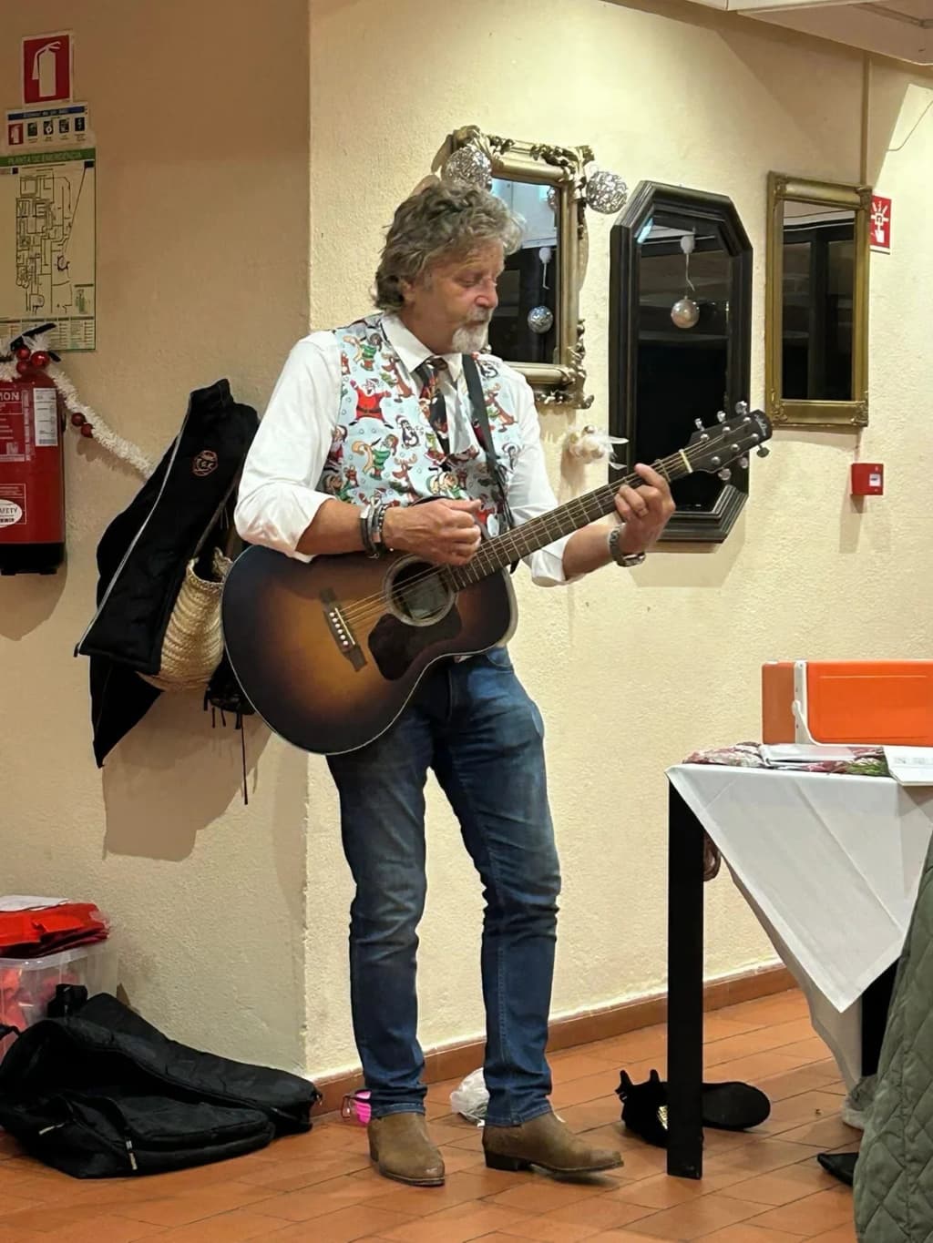 John Sanderson plays guitar and sings for PT Golf guests at a Christmas dinner in Eastern Algarve
