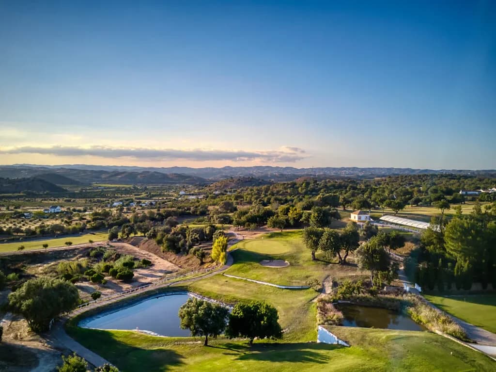Benamor Golf seen from above with the mountains in the background